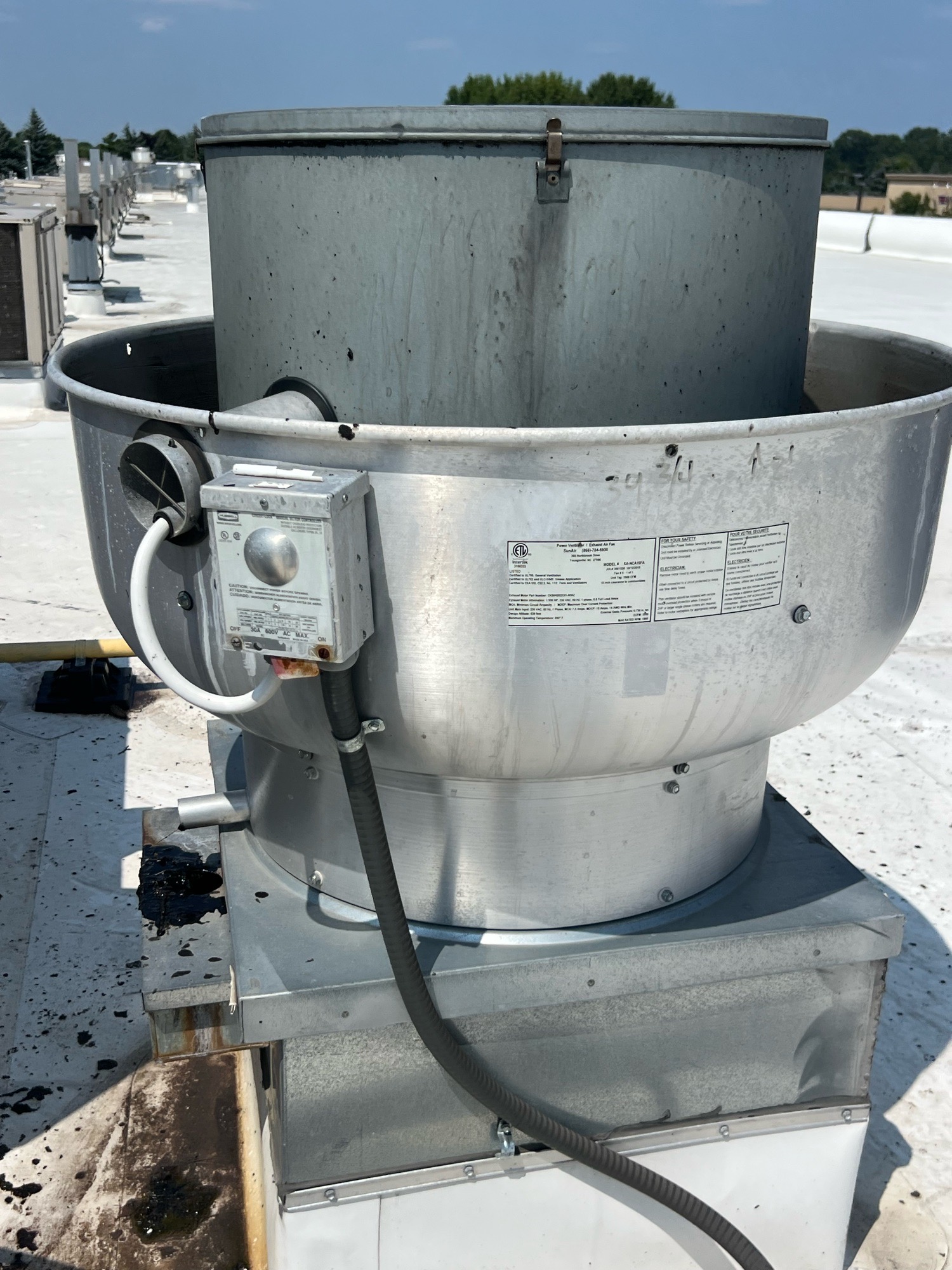 Rooftop exhaust fan inspection on a commercial building